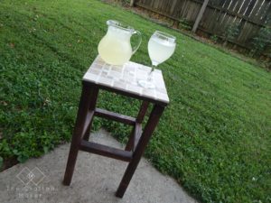 Add some decor to your outdoor party area. This DIY tiled end table with FREE PLANS is the perfect project to ring in the summer barbeque season.
