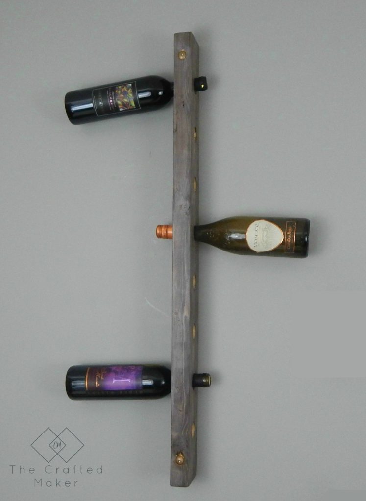 Build this DIY hanging wine rack out of one 2X4 board. For less than a bottle of wine, you can display your wine selection in style.