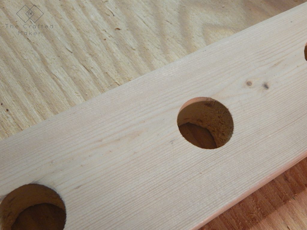 Build this DIY hanging wine rack out of one 2X4 board. For less than a bottle of wine, you can display your wine selection in style.