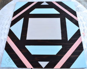 Make this fun geometric scrap wood wall art with scrap wood and paint you already have on hand. This is a quick, colorful, and creative afternoon project!